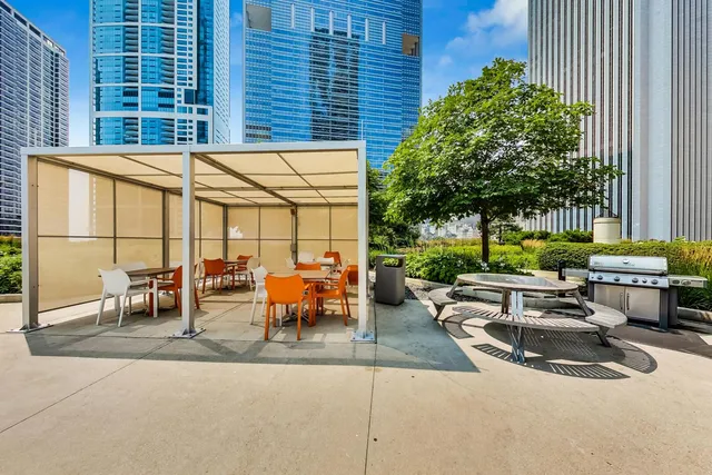a view of a patio with couches and table and chairs and potted plants