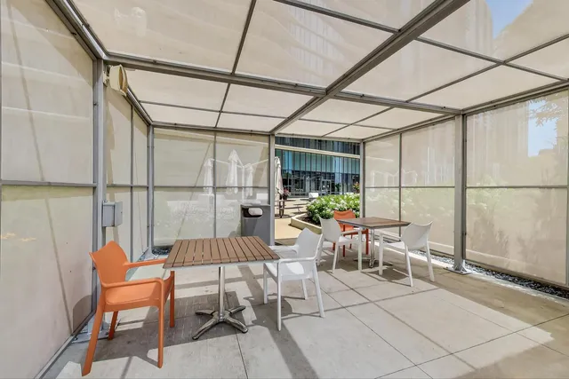 a swimming pool with outdoor seating and a potted plant