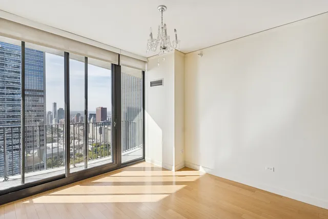 a view of a room with wooden floor and windows