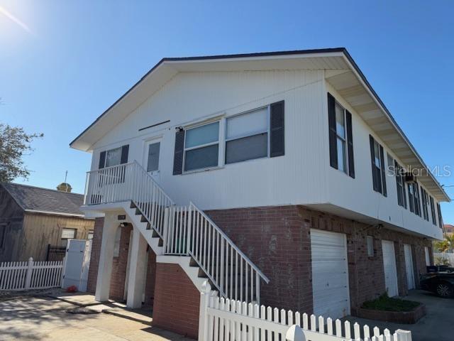 a view of a house with wooden fence