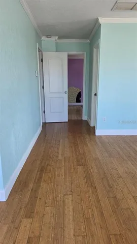 a view of a room with wooden floor and chair