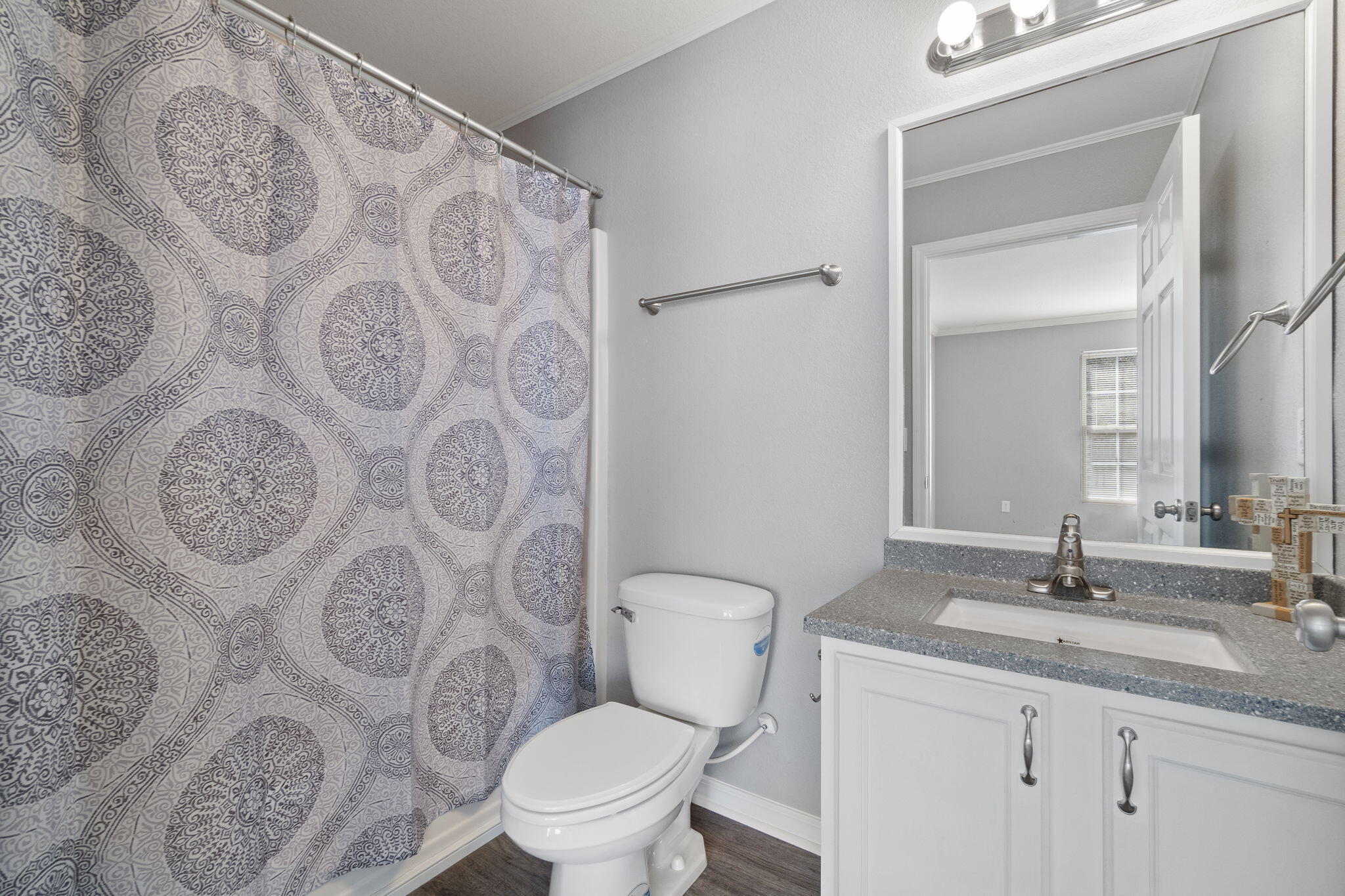 108 Corwin Drive Crestview, FL 32539 - Photo 12 of 20 a bathroom with a granite countertop toilet sink and mirror