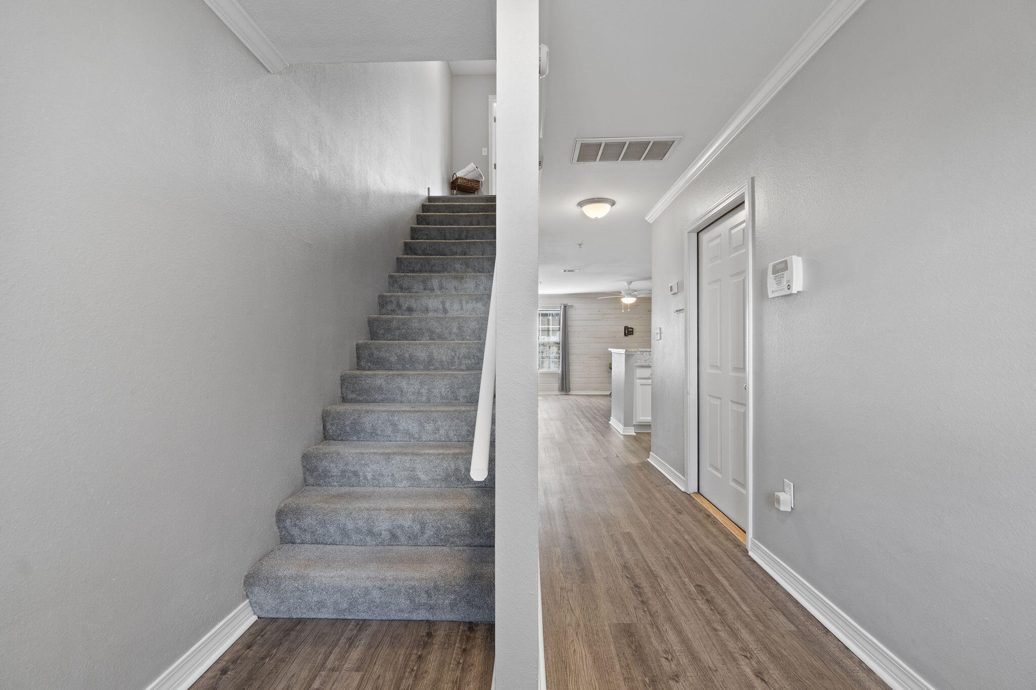 108 Corwin Drive Crestview, FL 32539 - Photo 14 of 20 a view of a hallway with wooden floor and entryway