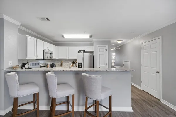 a kitchen with appliances a sink and cabinets