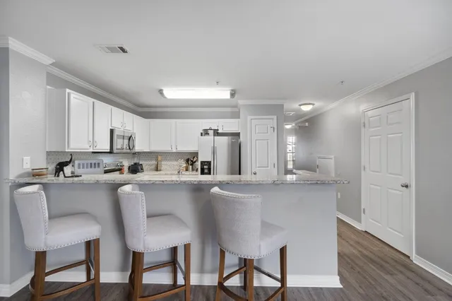 a kitchen with appliances a sink and cabinets