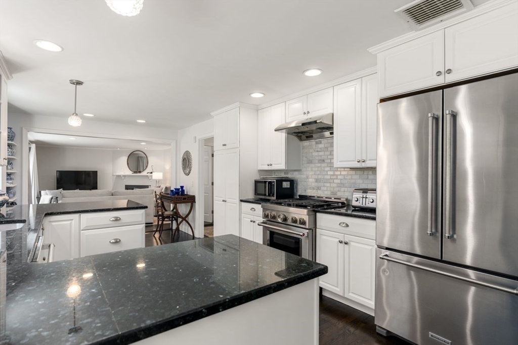 69 Royalston Road Wellesley, MA 02481 - Photo 11 of 31 a kitchen with stainless steel appliances granite countertop a refrigerator sink and cabinets