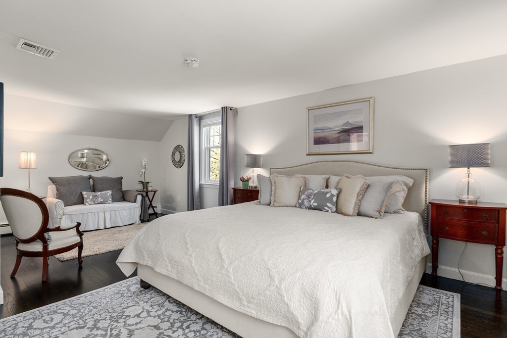 69 Royalston Road Wellesley, MA 02481 - Photo 19 of 31 a bedroom with a bed a lamp and a couch
