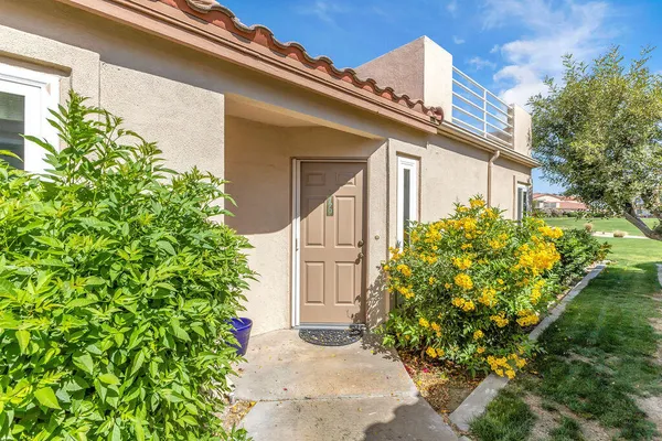 a view of a house with a flower garden
