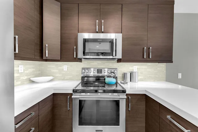 a kitchen with a stove a sink and cabinets