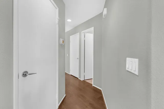 a view of a hallway with wooden floor