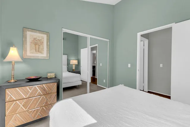 a bedroom with a bed and a lamp