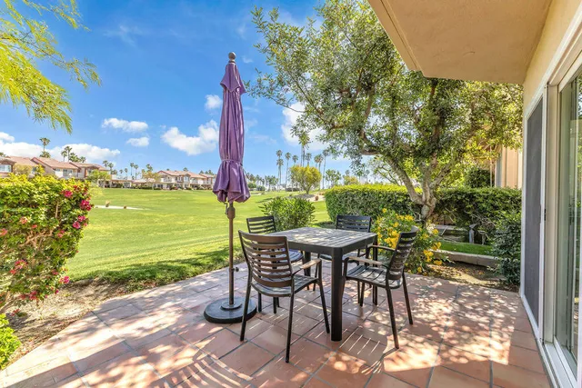 a view of a patio with a table chairs and a table and chairs