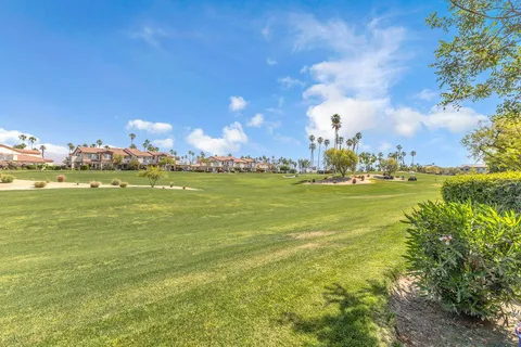 an aerial view of a house with a garden and lake view
