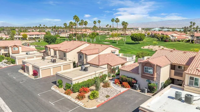 an aerial view of residential houses with outdoor space and river