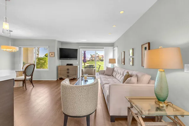 a living room with furniture a window and a flat screen tv