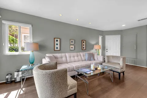 a living room with furniture and a potted plant