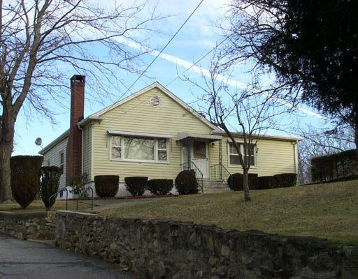 a view of a white house with a yard