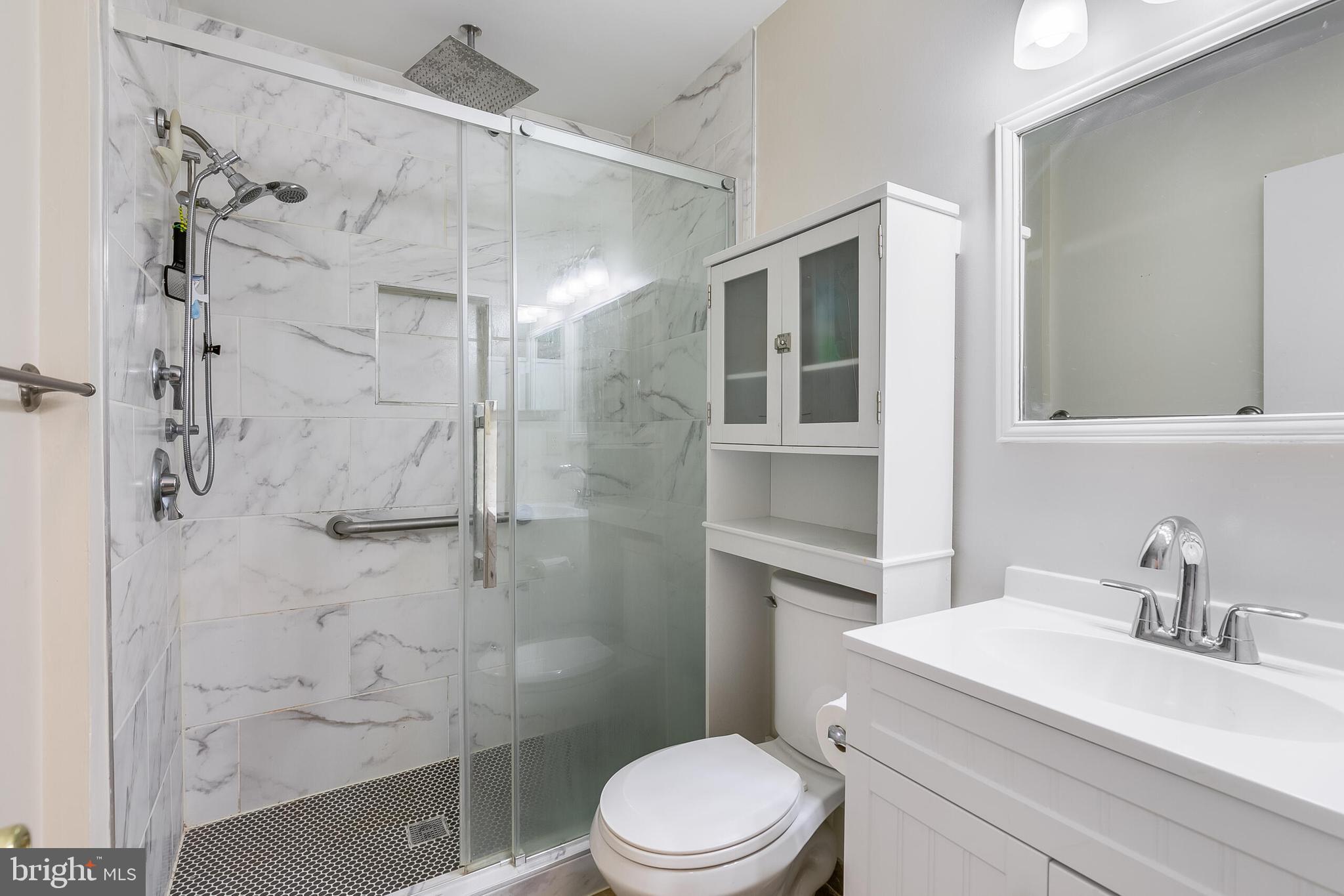 7329 Split Rail Lane Laurel, MD 20707 - Photo 22 of 32 a bathroom with a sink toilet vanity and shower