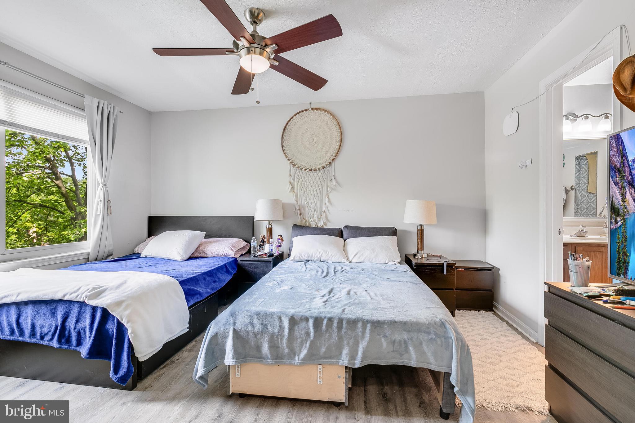 7329 Split Rail Lane Laurel, MD 20707 - Photo 23 of 32 a bedroom with a bed and dresser with wooden floor