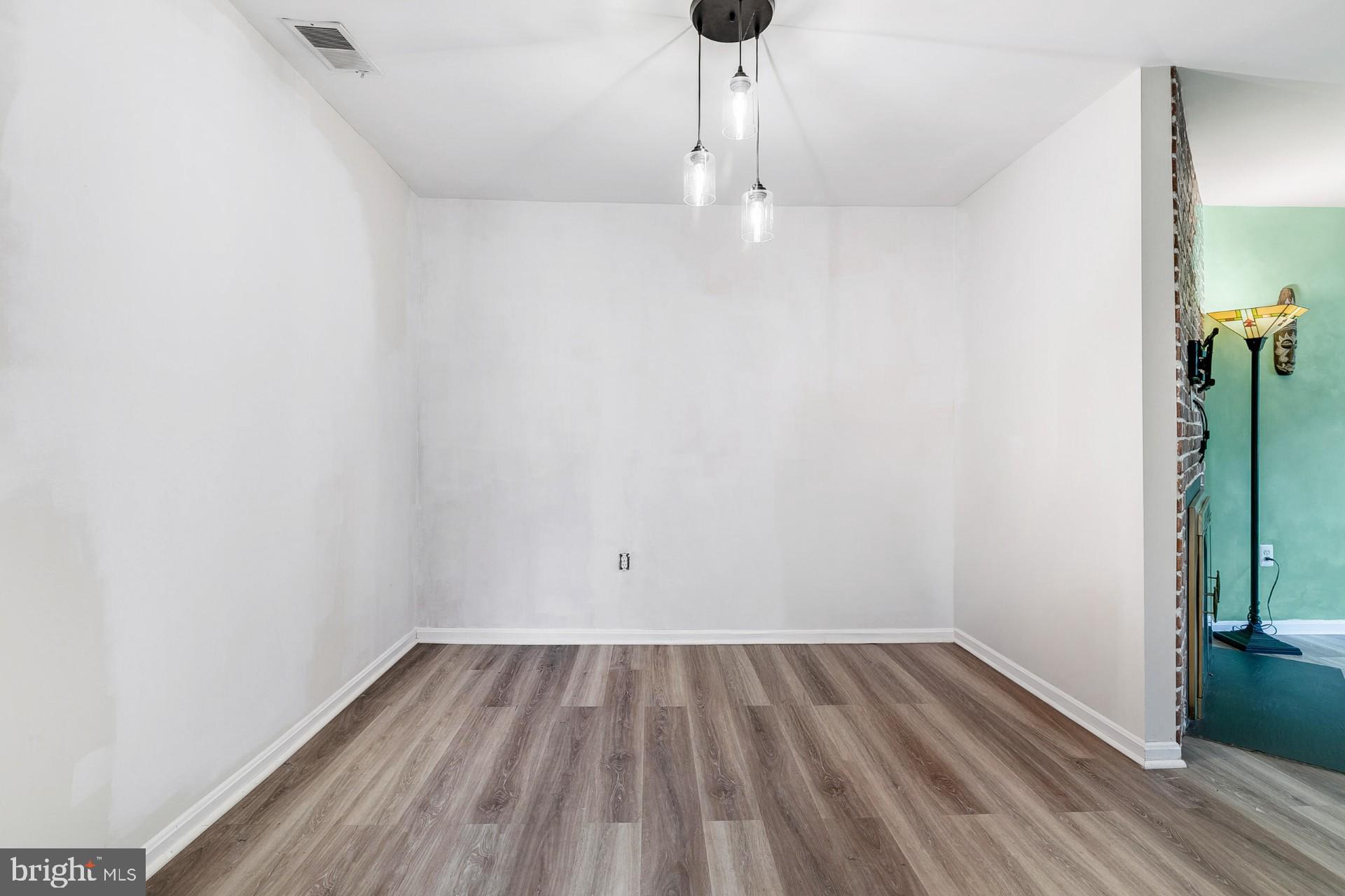 7329 Split Rail Lane Laurel, MD 20707 - Photo 7 of 32 a view of a room with wooden floor a ceiling fan and window