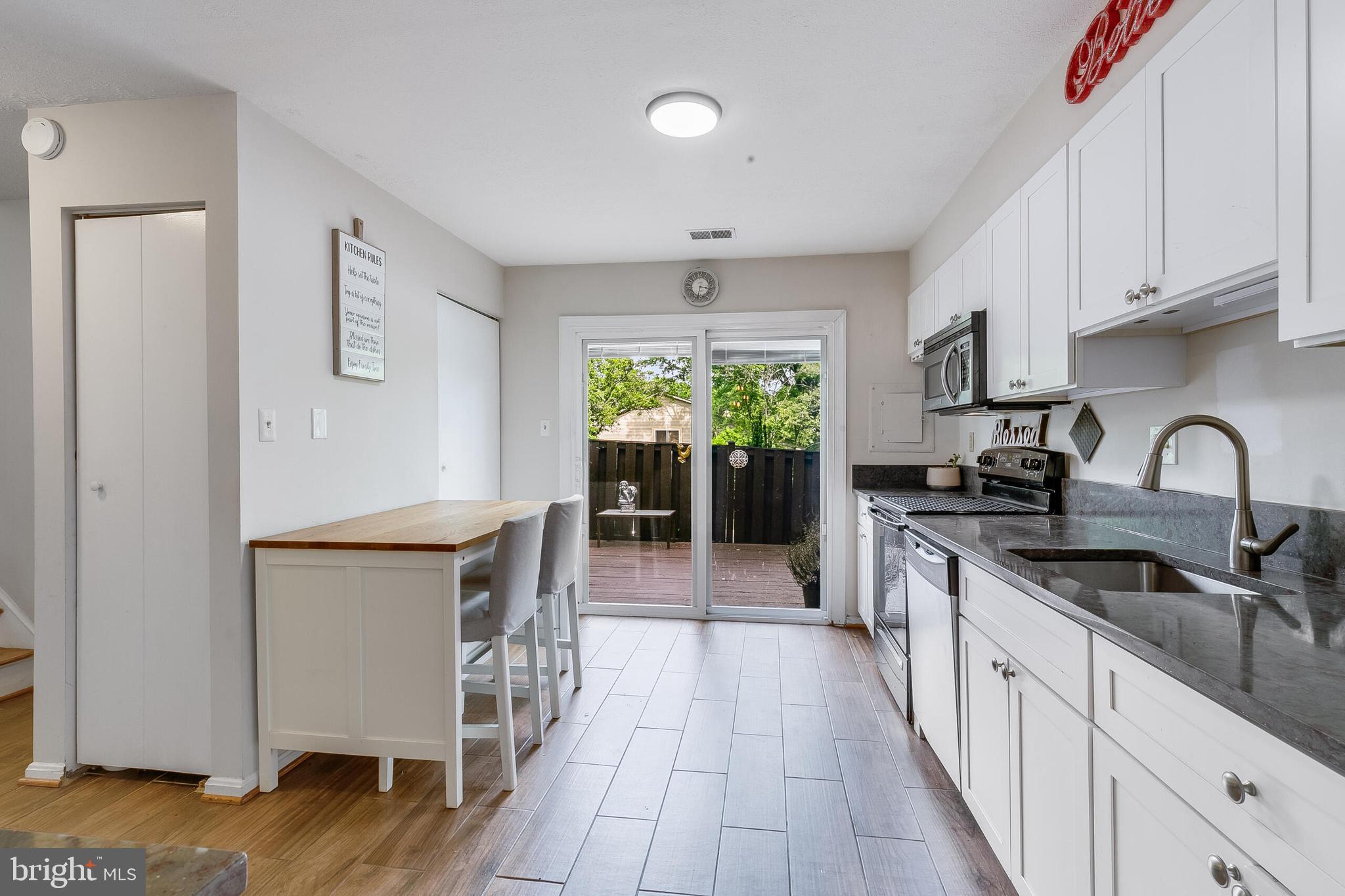 7329 Split Rail Lane Laurel, MD 20707 - Photo 8 of 32 a kitchen with stainless steel appliances granite countertop a stove a sink and a refrigerator