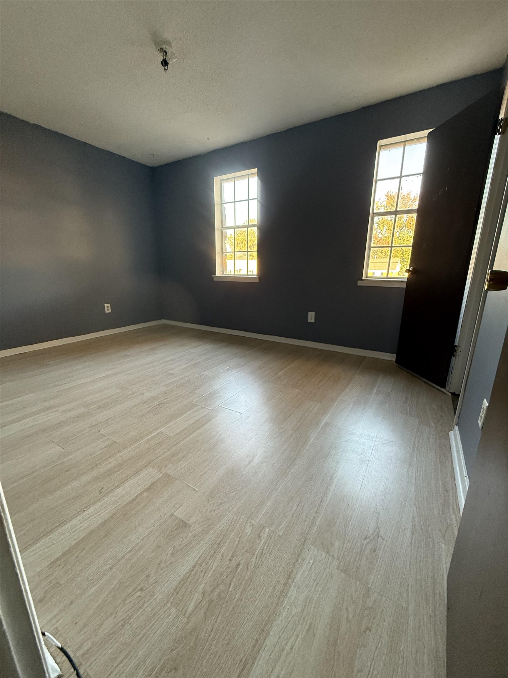 3091 Range Line Road Memphis, TN 38127 - Photo 13 of 13 Spare room with light wood-style flooring, healthy amount of natural light, and a textured ceiling