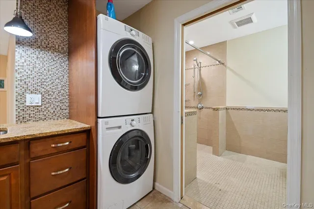 a kitchen with stainless steel appliances granite countertop a sink a stove and a refrigerator