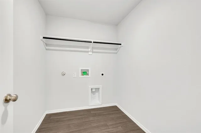 a view of a room with wooden floor