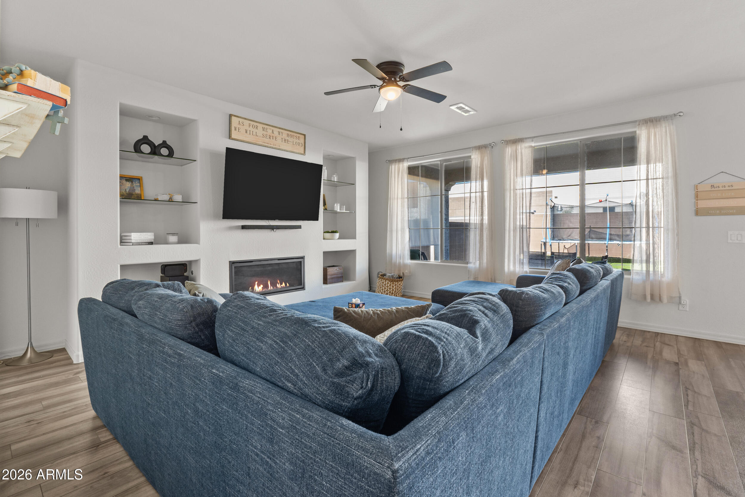 22978 East Pummelos Road Queen Creek, AZ 85142 - Photo 15 of 46 a living room with fireplace furniture and a flat screen tv