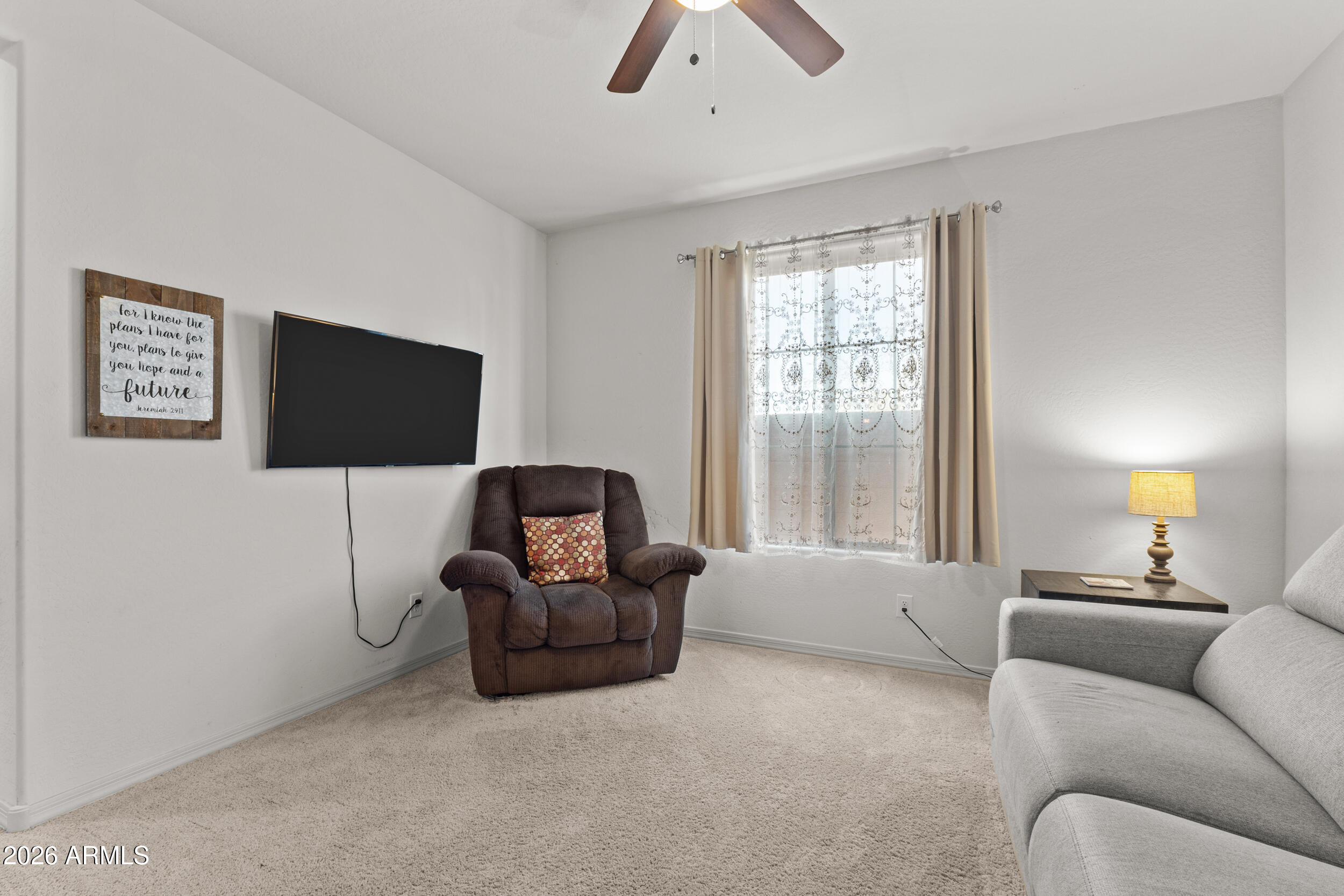 22978 East Pummelos Road Queen Creek, AZ 85142 - Photo 18 of 46 a living room with furniture and a flat screen tv