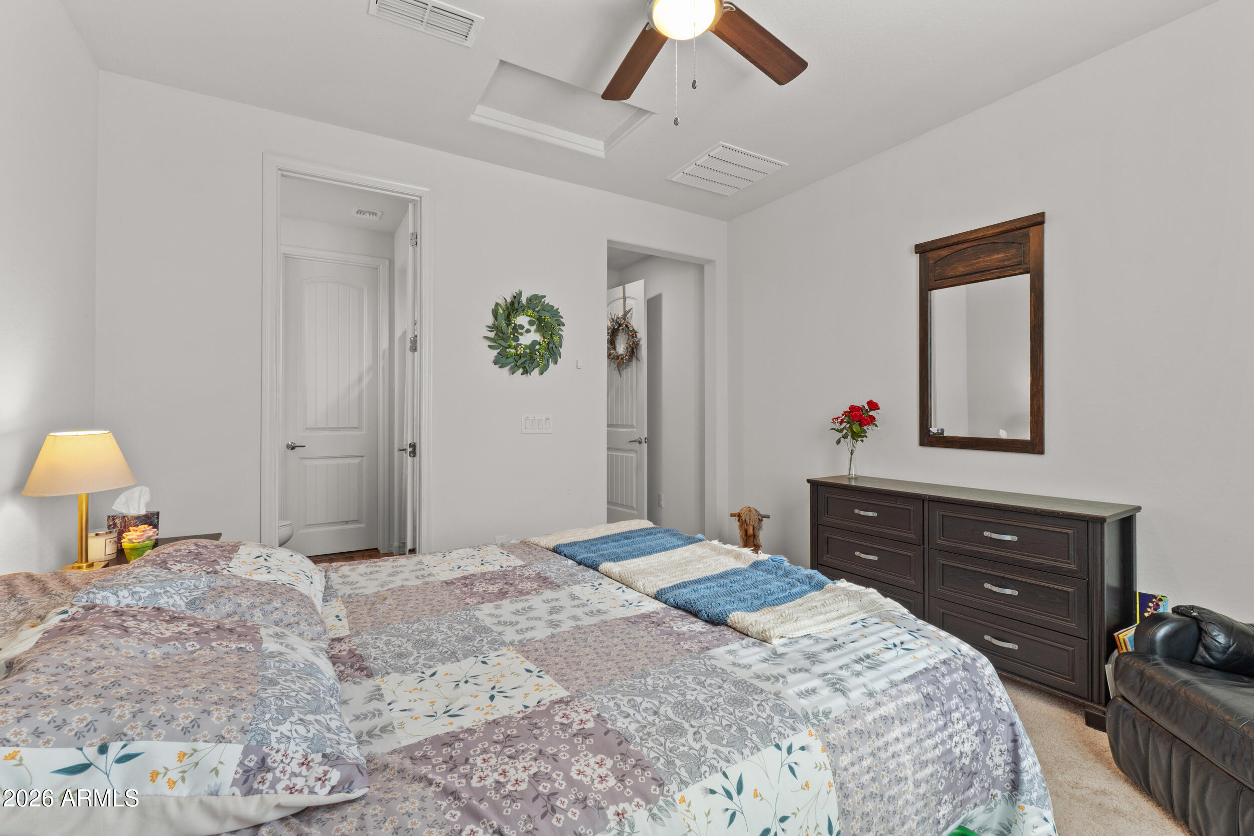 22978 East Pummelos Road Queen Creek, AZ 85142 - Photo 21 of 46 a bedroom with a bed and a dresser