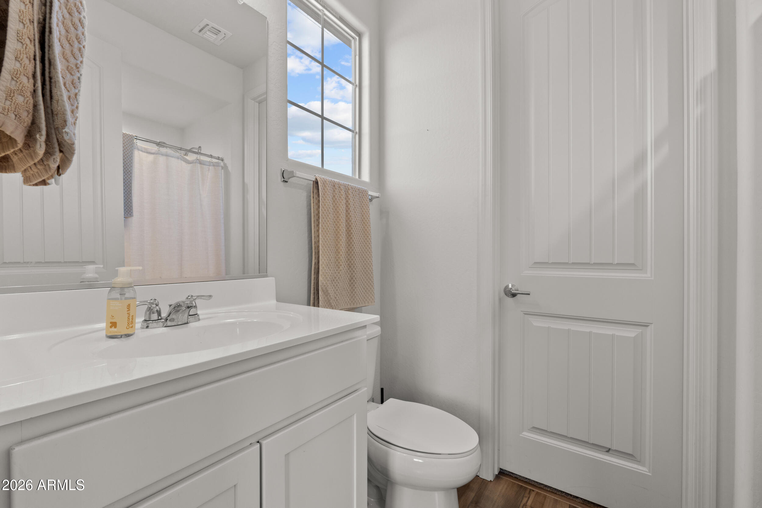 22978 East Pummelos Road Queen Creek, AZ 85142 - Photo 22 of 46 a bathroom with a sink toilet and vanity