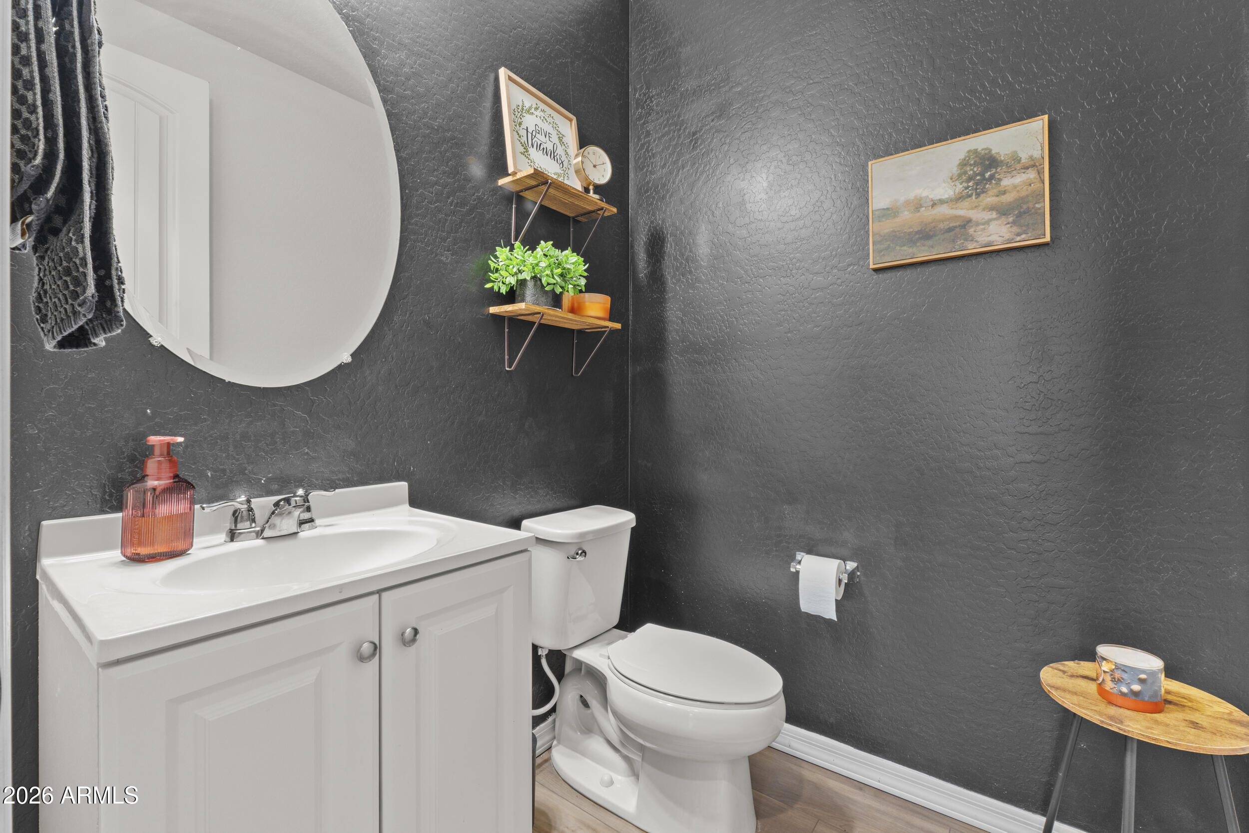 22978 East Pummelos Road Queen Creek, AZ 85142 - Photo 23 of 46 a bathroom with a toilet sink and mirror