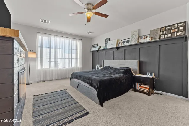 a view of a house with backyard water fountain and sitting area