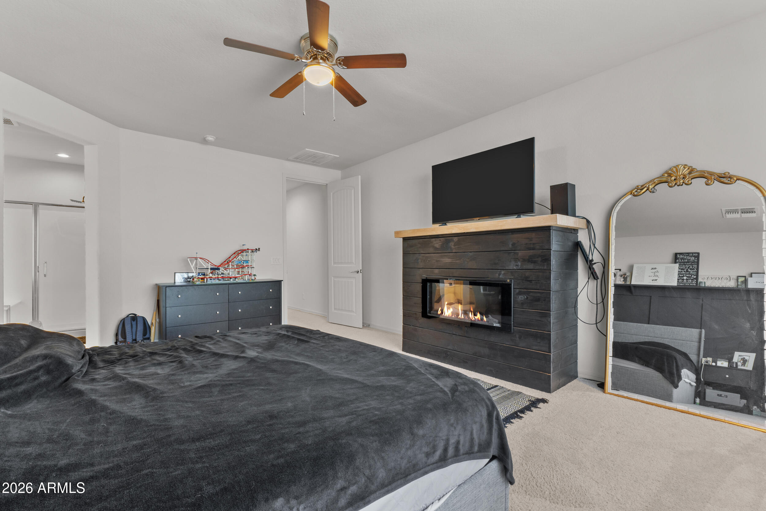 22978 East Pummelos Road Queen Creek, AZ 85142 - Photo 27 of 46 a bedroom with a bed and a fireplace