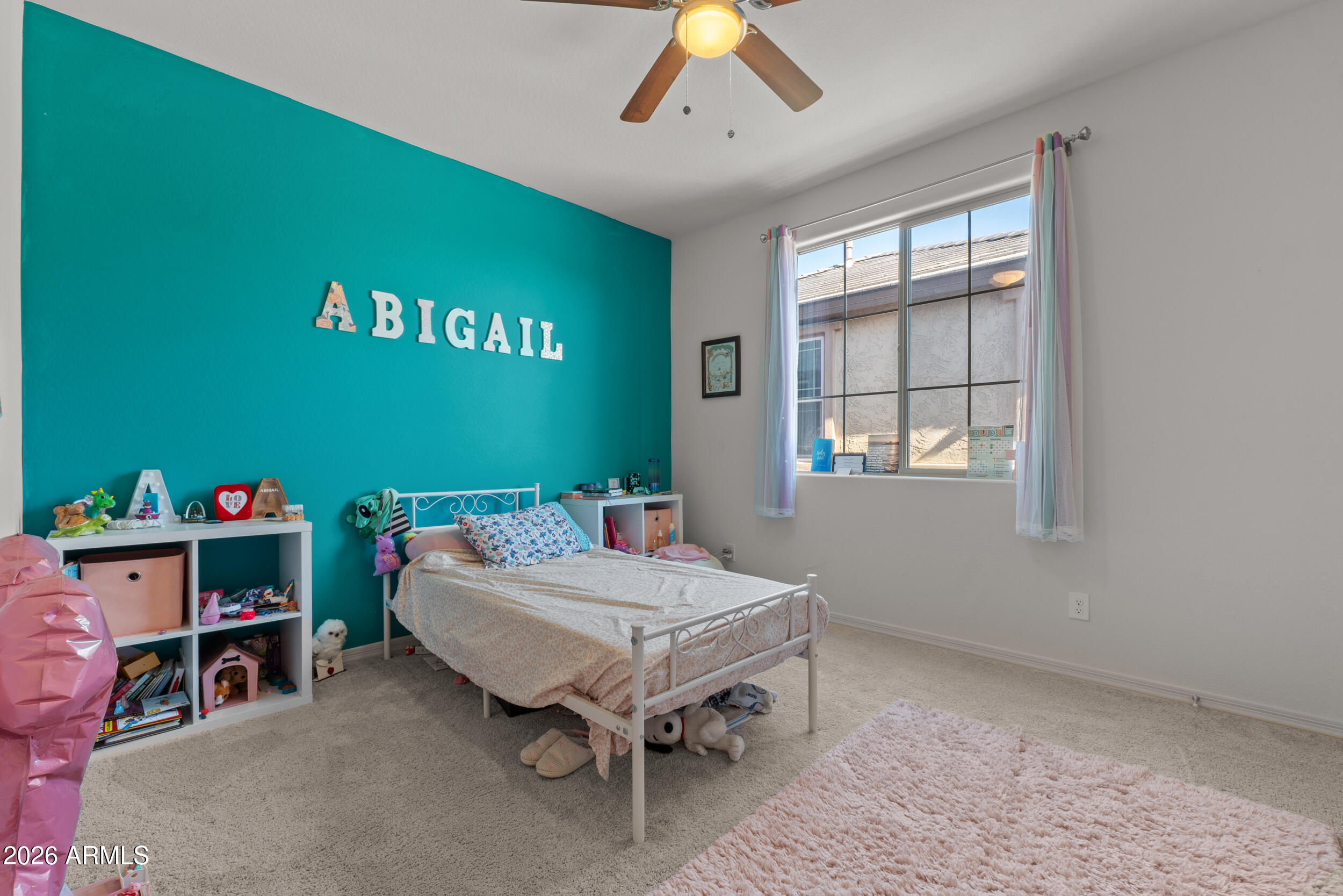 22978 East Pummelos Road Queen Creek, AZ 85142 - Photo 38 of 46 a room with furniture and a flat screen tv