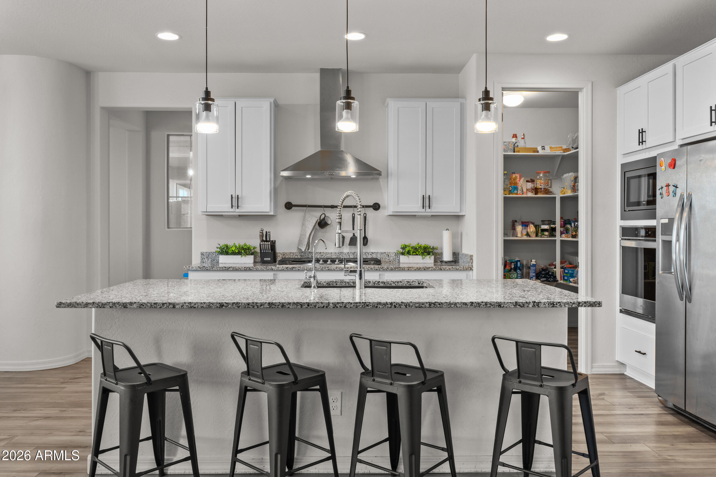 22978 East Pummelos Road Queen Creek, AZ 85142 - Photo 7 of 46 a kitchen with granite countertop stainless steel appliances a sink and a refrigerator