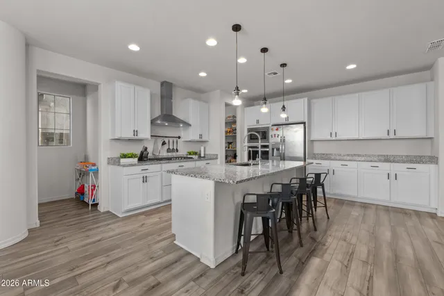 a living room with furniture kitchen and a chandelier
