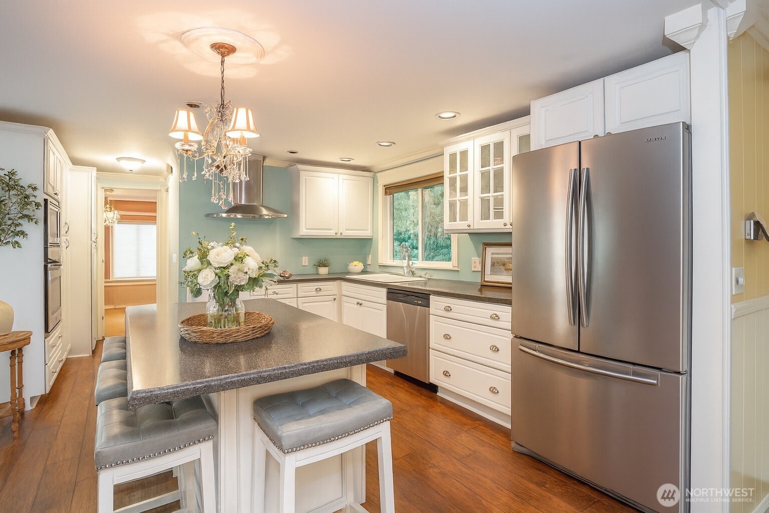 33507 43rd Avenue Southwest Federal Way, WA 98023 - Photo 15 of 40 a kitchen with stainless steel appliances a refrigerator a sink dishwasher a stove and white cabinets with wooden floor
