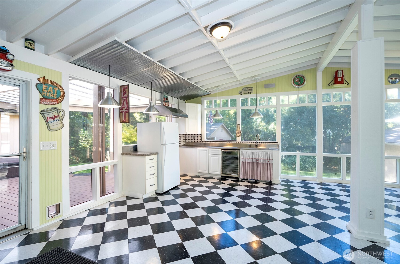 33507 43rd Avenue Southwest Federal Way, WA 98023 - Photo 21 of 40 a room with a black white checkered floor with a rug and a floor to ceiling window