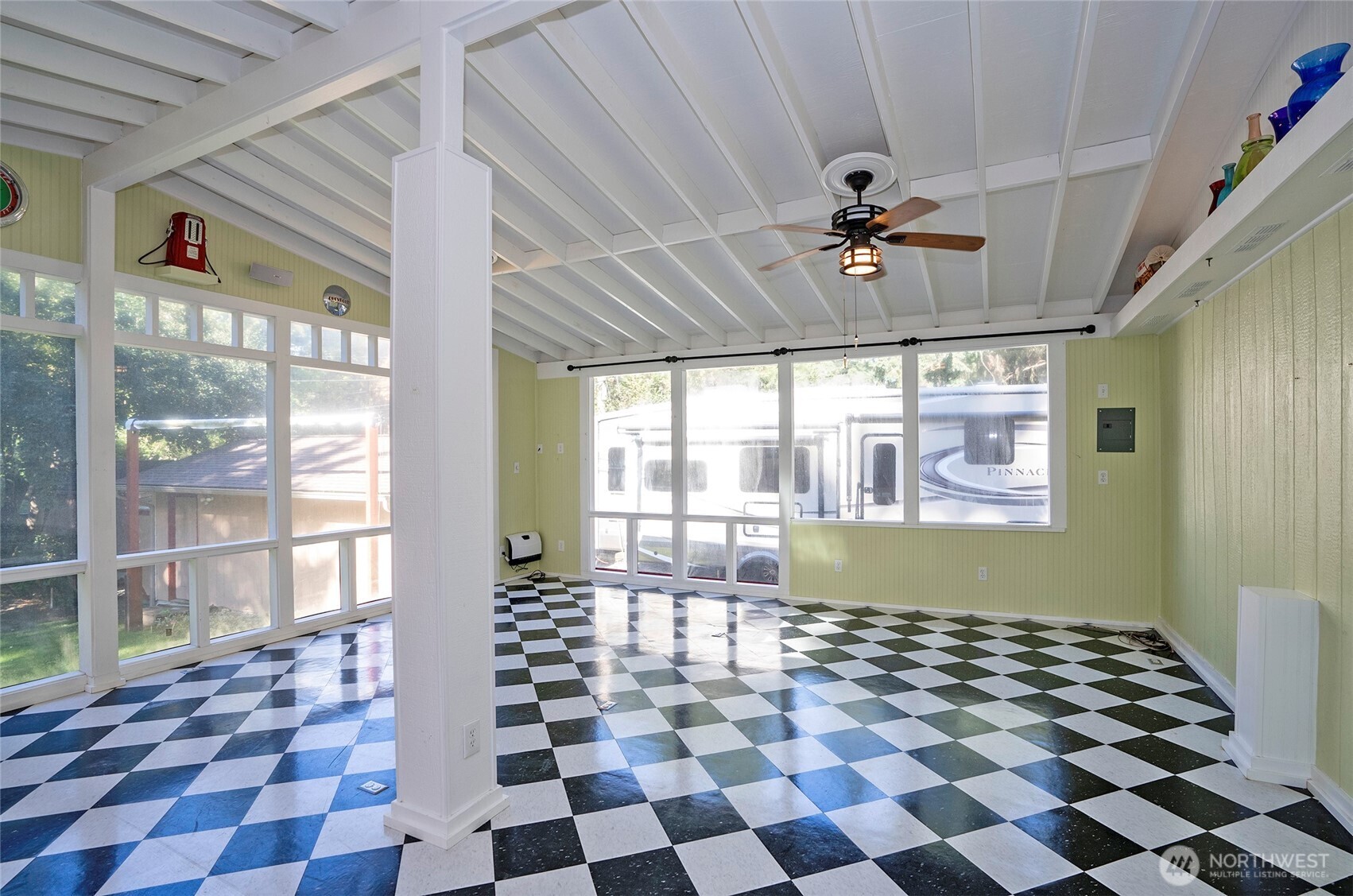 33507 43rd Avenue Southwest Federal Way, WA 98023 - Photo 22 of 40 a living room with a black white checkered floor with a gaming machine and dining space