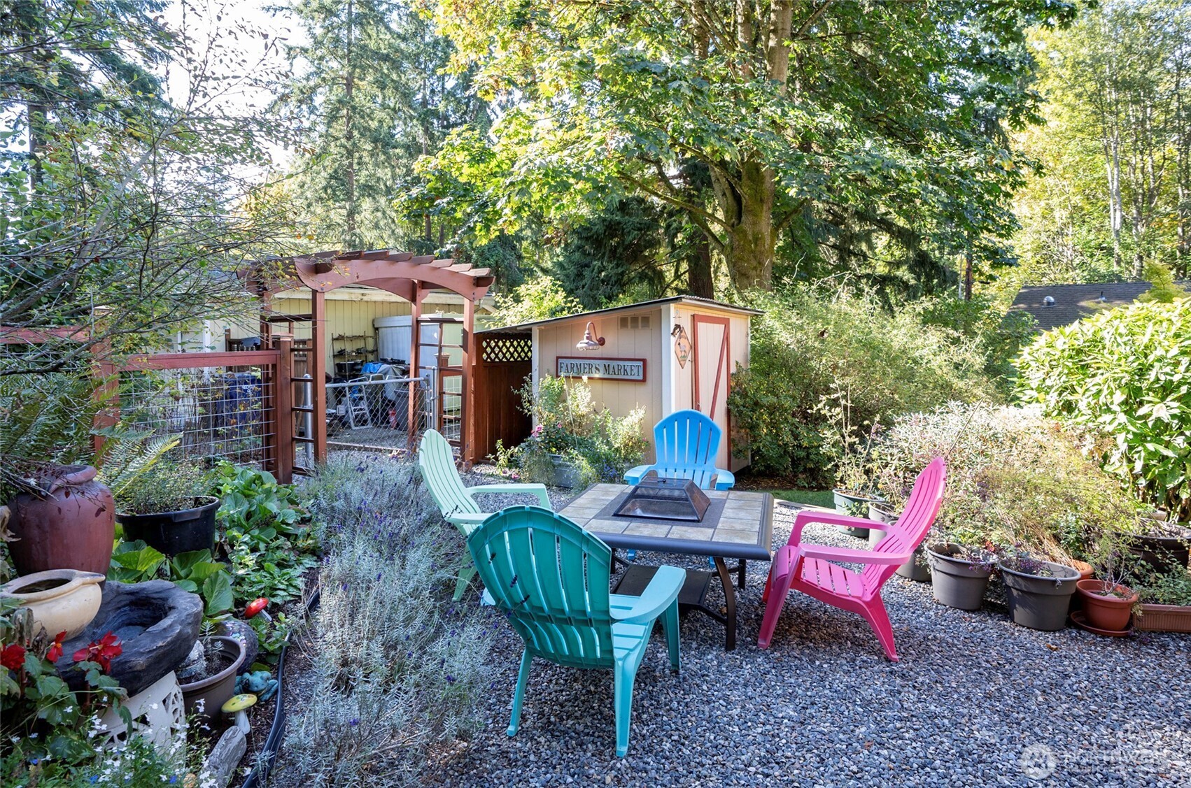33507 43rd Avenue Southwest Federal Way, WA 98023 - Photo 8 of 40 a view of a patio with table and chairs potted plants and large tree