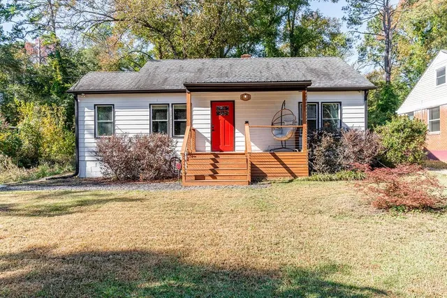 a view of a house with backyard and sitting area