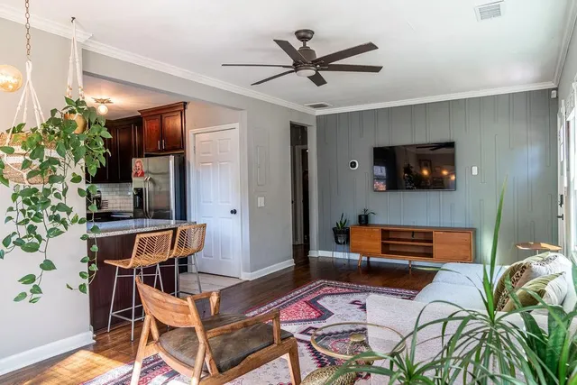 a living room with furniture and a flat screen tv