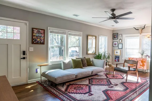 a living room with furniture ceiling fan and a window