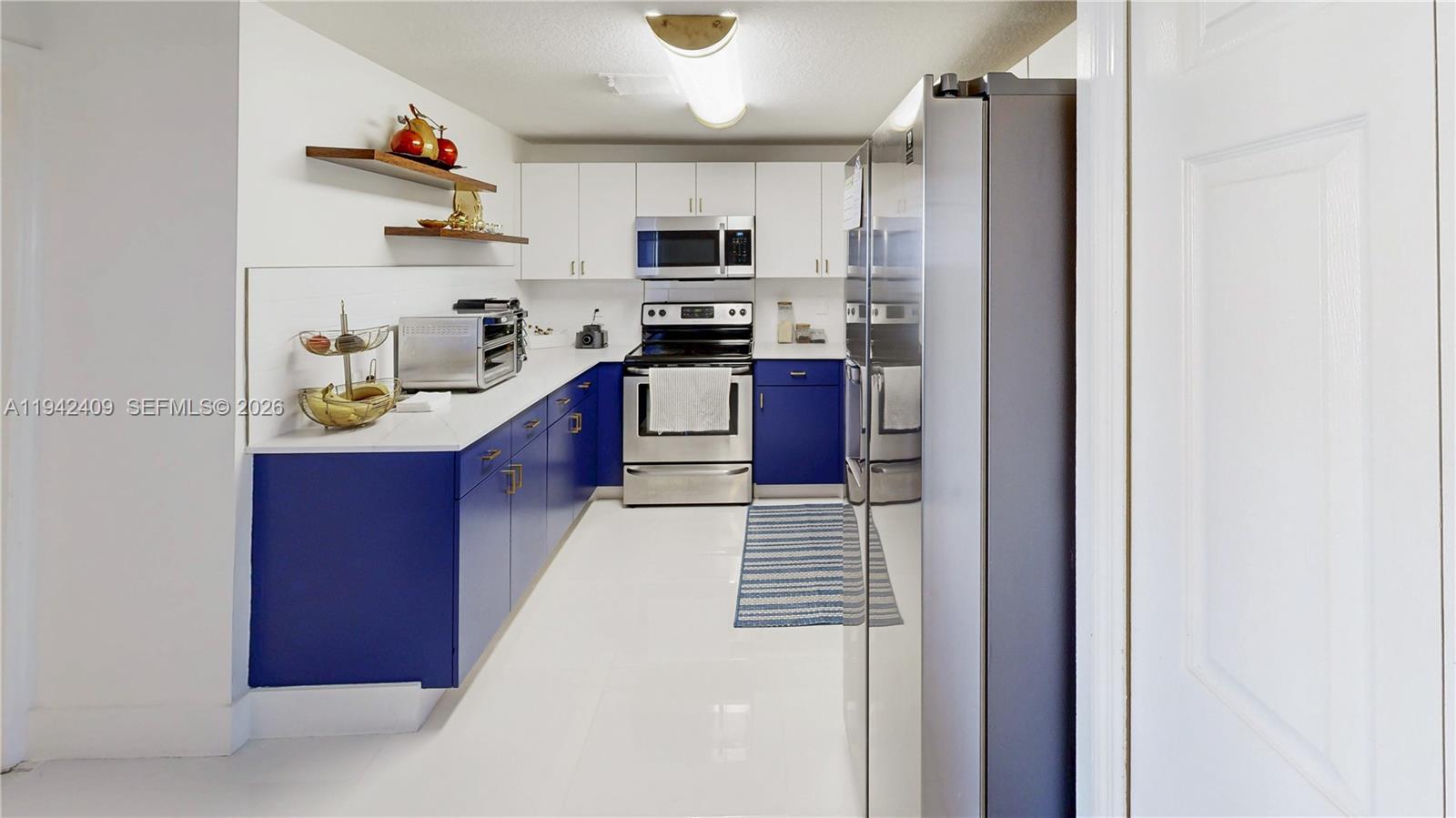 10210 Southwest 154th Place, Unit 1118 Miami, FL 33196 - Photo 16 of 71 a kitchen with stainless steel appliances granite countertop a refrigerator stove and sink