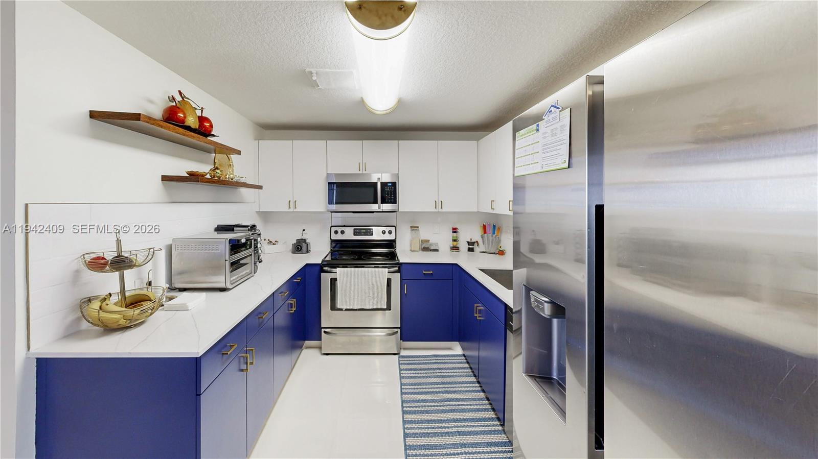 10210 Southwest 154th Place, Unit 1118 Miami, FL 33196 - Photo 17 of 71 a kitchen with a refrigerator a stove and a sink