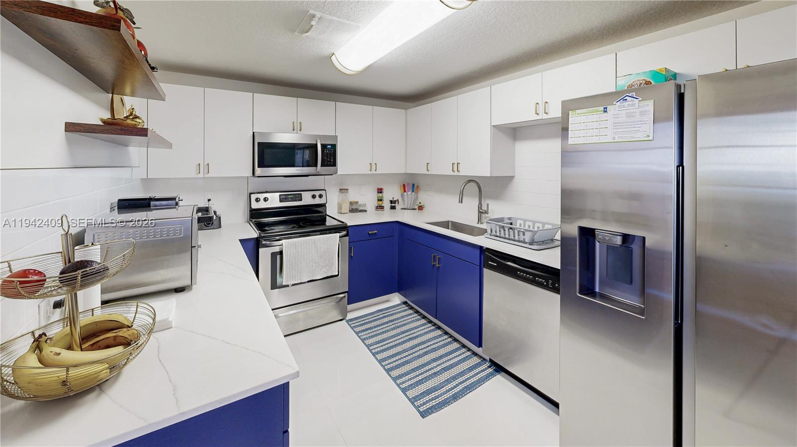 10210 Southwest 154th Place, Unit 1118 Miami, FL 33196 - Photo 18 of 71 a kitchen with stainless steel appliances granite countertop a sink stove and refrigerator