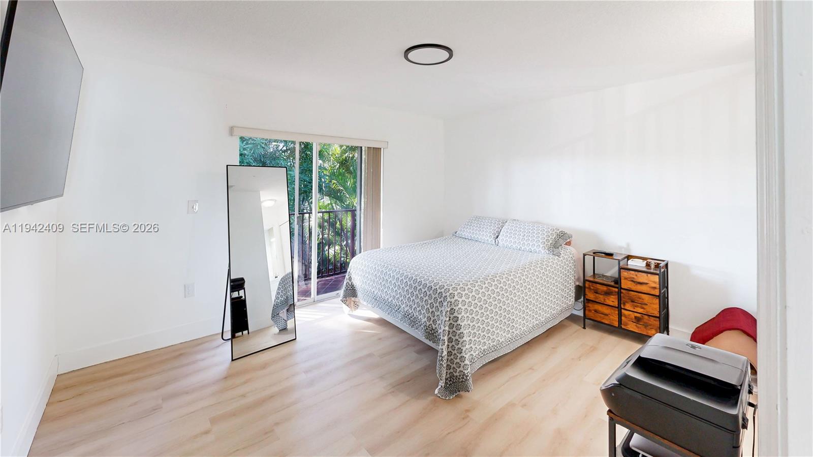 10210 Southwest 154th Place, Unit 1118 Miami, FL 33196 - Photo 22 of 59 a bedroom with a bed and wooden floor