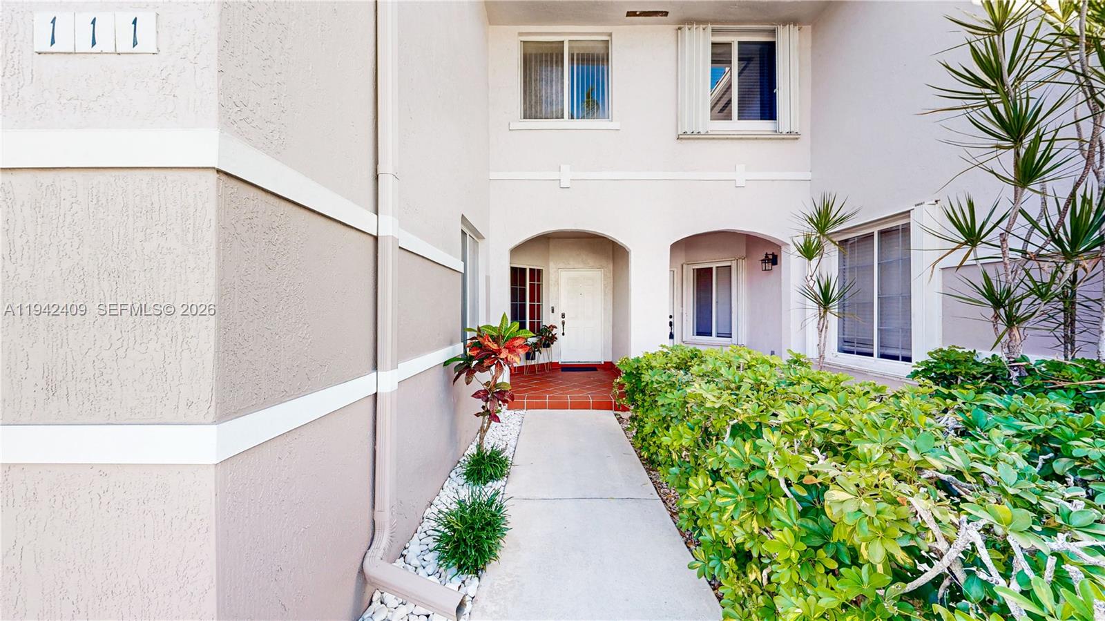 10210 Southwest 154th Place, Unit 1118 Miami, FL 33196 - Photo 3 of 59 a view of a house with a flower garden
